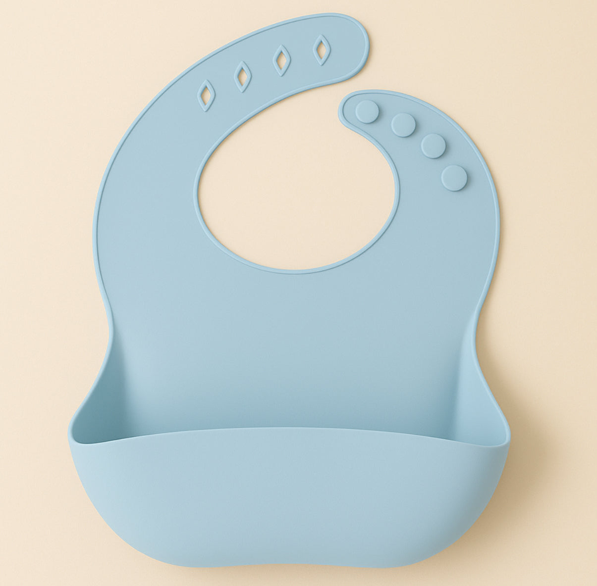 Loomie silicone bib with adjustable neck strap and front pocket, designed for meal time protection and easy cleaning.